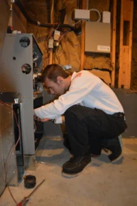 Tech Repairing HVAC Unit