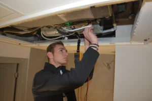 Tech Repairing HVAC Unit